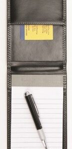 A pen and note pad sitting on top of a table.