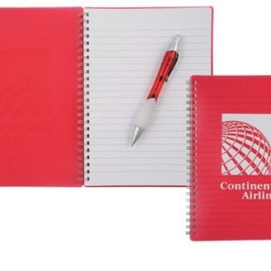 A red notebook with a pen on top of it.