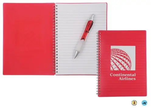 A red notebook with a pen on top of it.