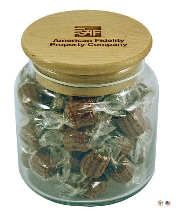 A jar of chocolate covered peanuts with a wooden lid.