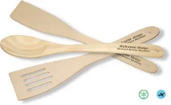 A wooden spoon and fork with the words " welcome home ".