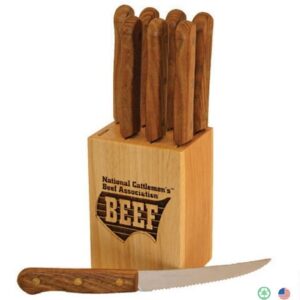 A wooden block with six steak knives in it.