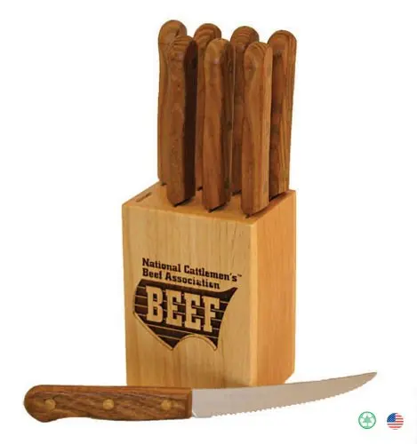 A wooden block with six steak knives in it.