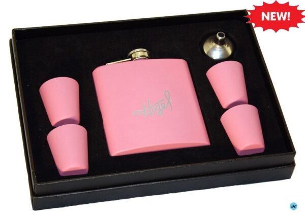 A pink flask and four shot glasses in a box.