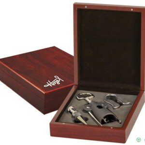 A wooden box with four wine accessories in it.
