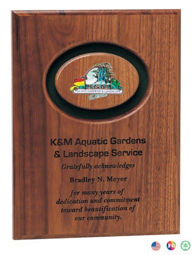 A plaque with the logo of kem aquatic gardens and landscape service.