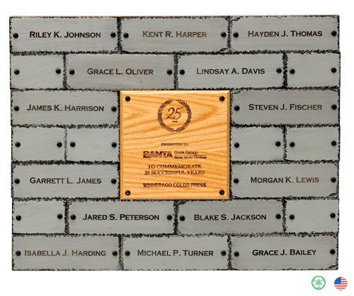 A brick wall with plaques of names on it.