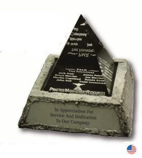 A pyramid shaped award with a plaque on top.