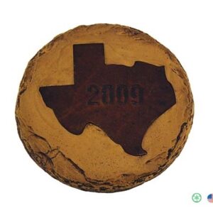 A brown and black texas shaped cookie sitting on top of a table.