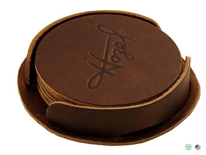 A brown leather coaster set with the word " hope ".