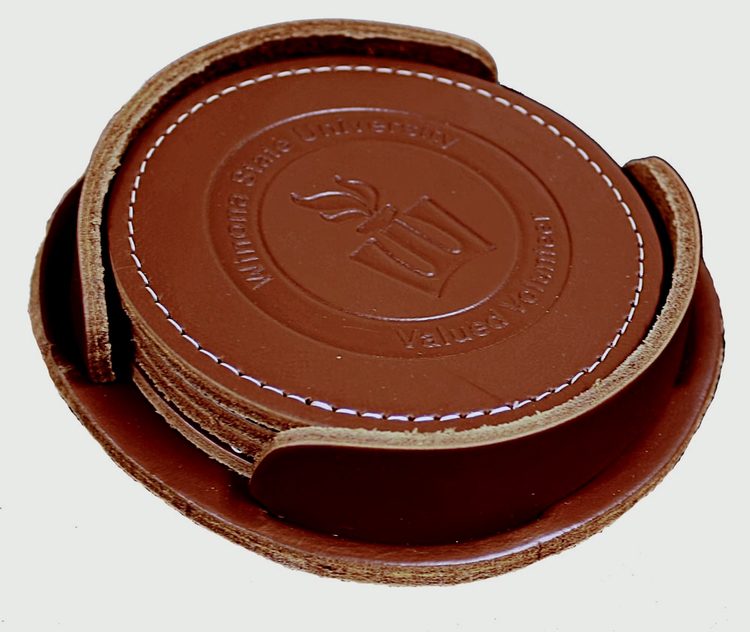 A brown leather coaster set with the number 2 5.