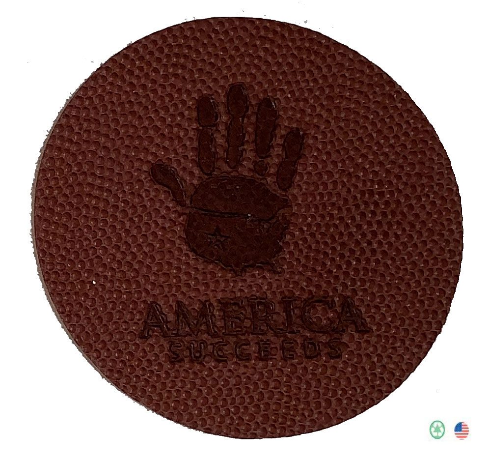 A brown leather coaster with an image of a hand.