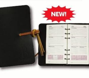 A new planner is in its box and has the cover open.