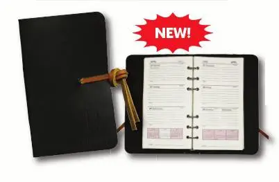 A new planner is in its box and has the cover open.