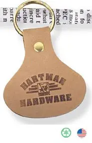 A leather key chain with the hartman hardware logo.