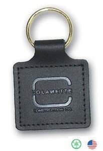 A black leather key chain with the name colambette on it.