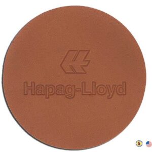 A brown round coaster with the name of hepag-lloyd