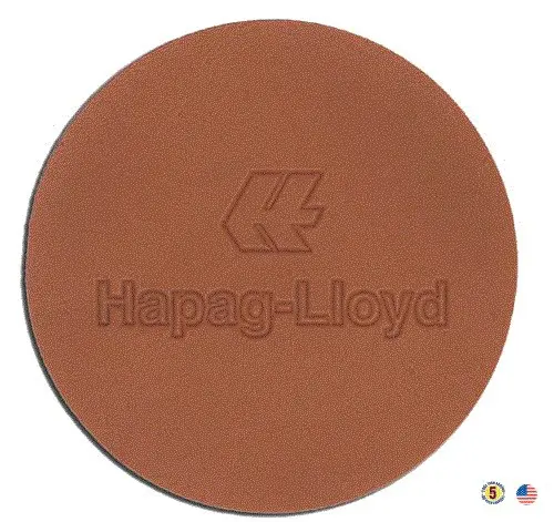 A brown round coaster with the name of hepag-lloyd