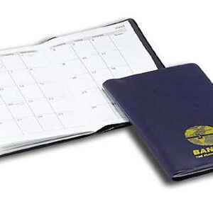 A blue passport and calendar sitting on top of the table.