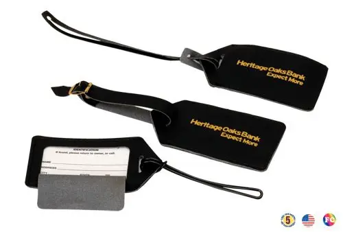 A group of luggage tags with name cards attached.